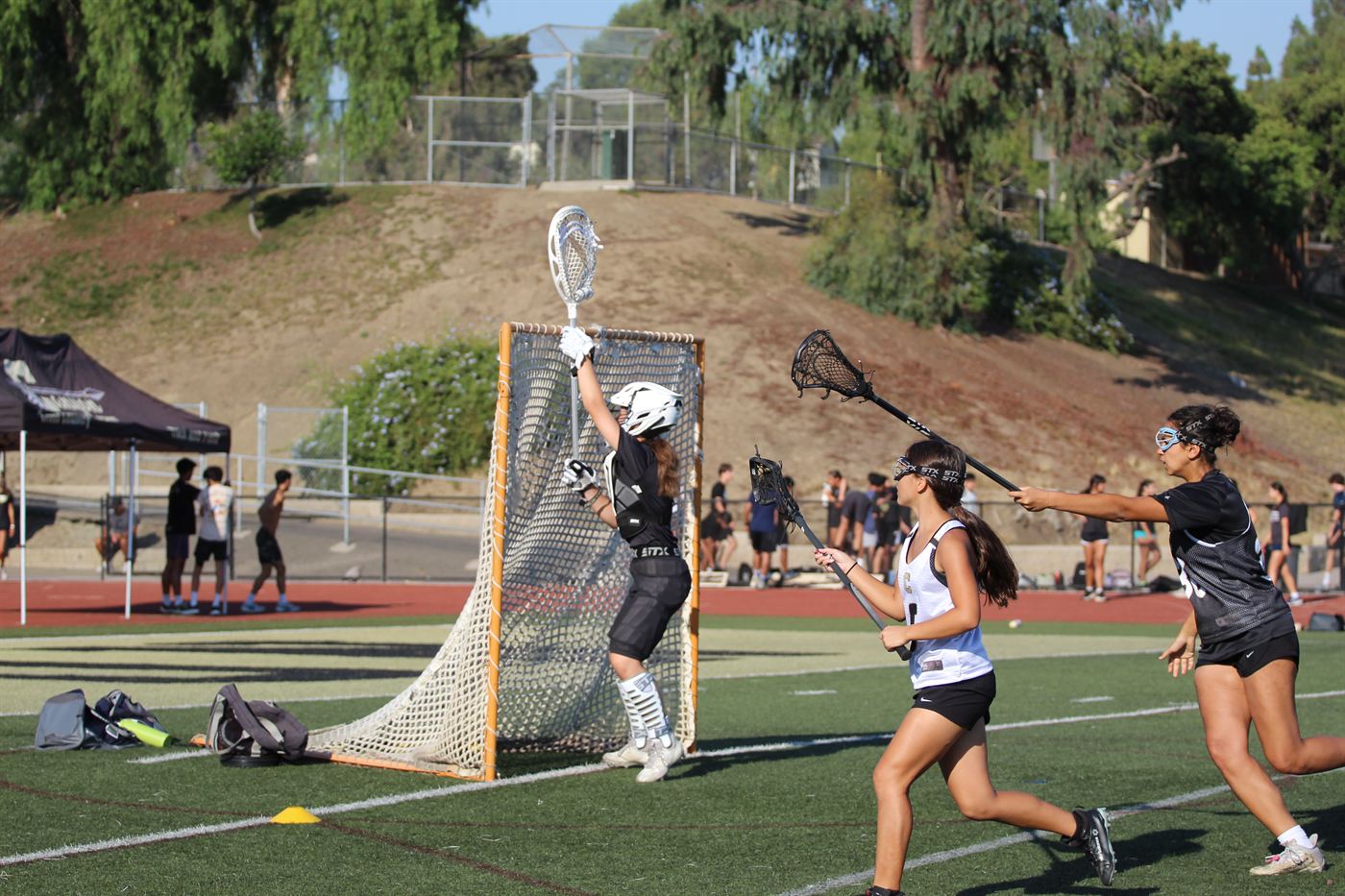 A Canyon goalkeeper reaches up to make a save as attackers close in.